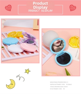 Close-up of foldable macaron-colored makeup mirrors in blue, white, and pink