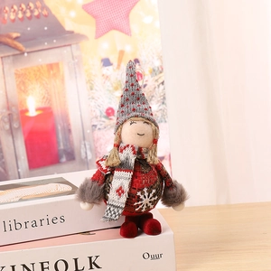 Close-up of a Christmas plush gnome with red plaid fabric and a gray knit hat