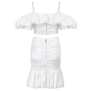 Detail of white satin two-piece set with pearl straps and ruffled off-shoulder crop top