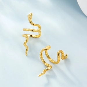 Detailed macro view of S925 sterling silver snake earrings with golden textured scales