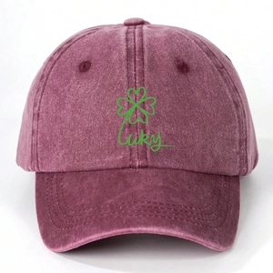 Detail of burgundy washed cotton baseball cap with green clover and Lucky embroidery