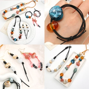 Handmade two-tone acrylic bead jewelry set featuring marble texture necklaces and earrings
