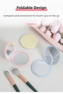 Three colorful round folding makeup mirrors displayed with floral and cosmetic props