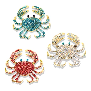 Three creative gold-plated crab brooches with sparkling blue red and white rhinestones