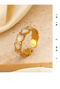 Detailed shot of a gold heart-shaped open ring with white mother of pearl inlays