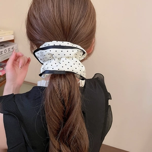 French style polka dot satin scrunchie shown in a low ponytail on a female model
