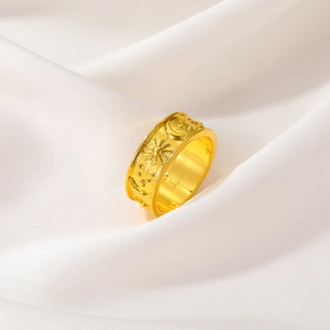 Detailed relief of vintage sun, moon, and stars on a gold-plated wide band ring