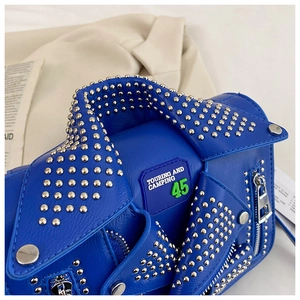 Detail of electric blue jacket-shaped bag with silver rivets and metal zipper accents