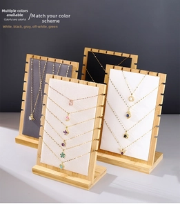 Detailed view of bamboo necklace displays with various black and white velvet liners