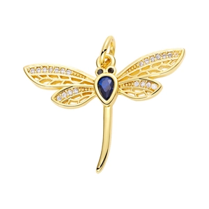 Macro view of golden dragonfly pendant with blue gemstone and clear crystals for jewelry
