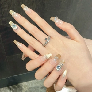 Elegant nude cat-eye press-on nails with shimmering K9 rhinestones and glitter decor