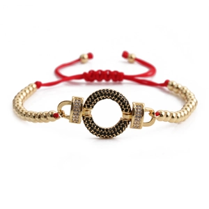 Red braided rope bracelet with gold beads and a black and white zircon pavé ring