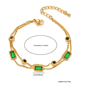 Detail of double-layer gold clover bracelet with green crystals and adjustable clasp