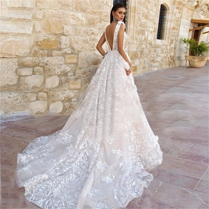 Elegant V-neck backless bridal gown with floral lace embroidery and a long chapel train