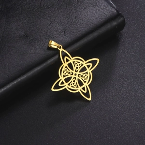 Close-up of golden stainless steel Celtic knot pendant on black textured surface