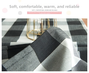 Close-up of black and white checkered Christmas table runner fabric with woven texture