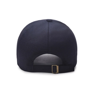 Rear view of navy blue cotton baseball cap with adjustable metal buckle on white background