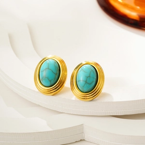 Macro shot of vintage oval turquoise earrings with 18K gold-plated textured finish