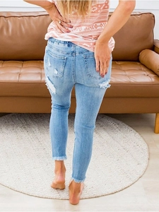 Light blue ripped skinny jeans for women with back pocket distressing and frayed hems