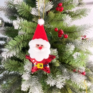 Star-shaped Santa Claus plush ornament with red sequins on a snowy Christmas tree branch