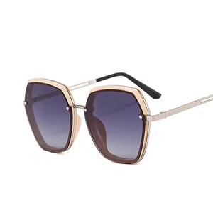 Champagne gold metal sunglasses with dark gray gradient lenses and geometric oversized frames