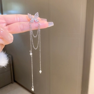 Detail view of silver butterfly ear cuff with shimmering zircon tassels and white pearls