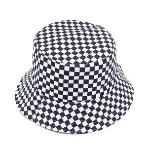 Detailed view of reversible black and white checkerboard bucket hat with cotton texture