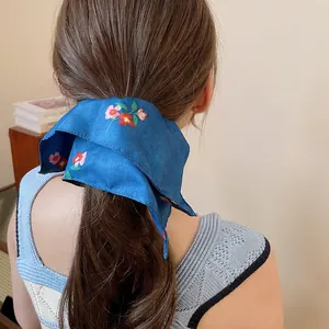 Navy blue floral silk scrunchie with ribbons for women in elegant low ponytail style