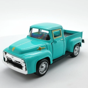 Close-up of vintage cyan alloy pickup truck model with chrome details on white background