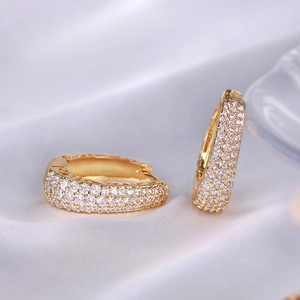 Chic gold huggie hoop earrings with micro-pave cubic zirconia on elegant silk fabric