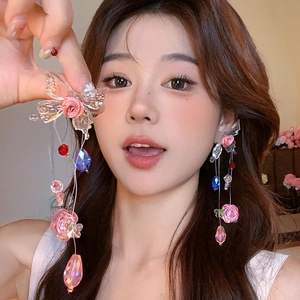 Detail of crystal tassel earrings with pink roses and transparent butterfly charms