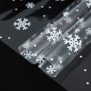 Transparent Christmas cellophane rolls with white snowflake patterns for flower wrapping