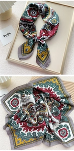 Detail of elegant satin square scarf featuring vintage paisley patterns and rich colors