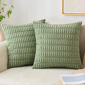 Detailed texture of green corduroy pillow covers on a cozy sofa with home decor