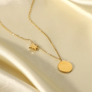 18K gold plated stainless steel necklace with star pendant on beige silk