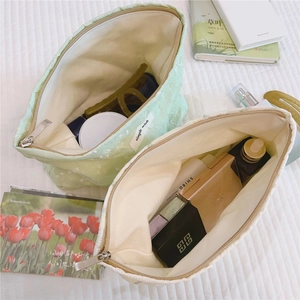 Macro detail of textured canvas makeup bags with metal zippers and spacious interior