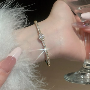 Close-up of gold plated oval zircon bracelet on wrist with elegant luxury detailing