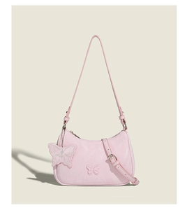Detailed view of pink butterfly shoulder bag with nylon fabric and decorative charm
