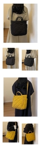 Detailed view of black and yellow quilted nylon tote bags showing handles and straps