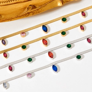 Gold and silver snake chains with colorful oval and marquise zircon pendants on white background