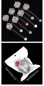 Macro view of stainless steel tea infuser with heart-shaped crystal stone pendants