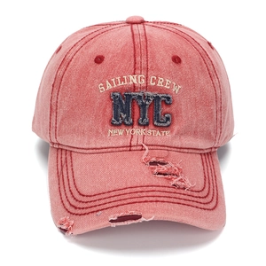 Distressed red washed denim baseball cap with blue NYC embroidery and ripped details