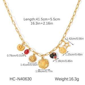 Detail view of gold necklace with sun, moon, and heart charms including size dimensions
