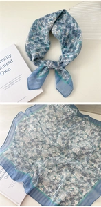 Detail of blue floral cotton linen scarf showing delicate fabric texture and pattern