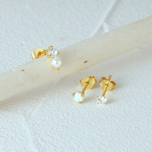 Detail of 925 sterling silver stud earrings set featuring pearl and colorful opal stones