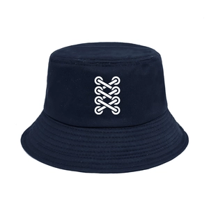 Detail of navy blue cotton bucket hat featuring a white cross-lace screen print pattern