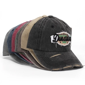 Multi-color vintage washed cotton baseball caps with embroidered patches stacked on white