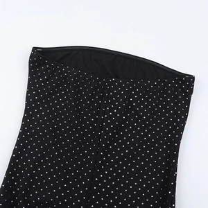 Close-up detail of silver rhinestones and sequins on black wide-leg jumpsuit fabric