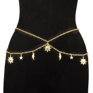 Sexy golden body chain with sun, moon, and star charms shown on a model against black background