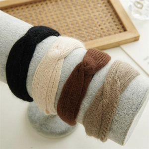 Detail showing the knitted texture and knot design of plush headbands in four colors